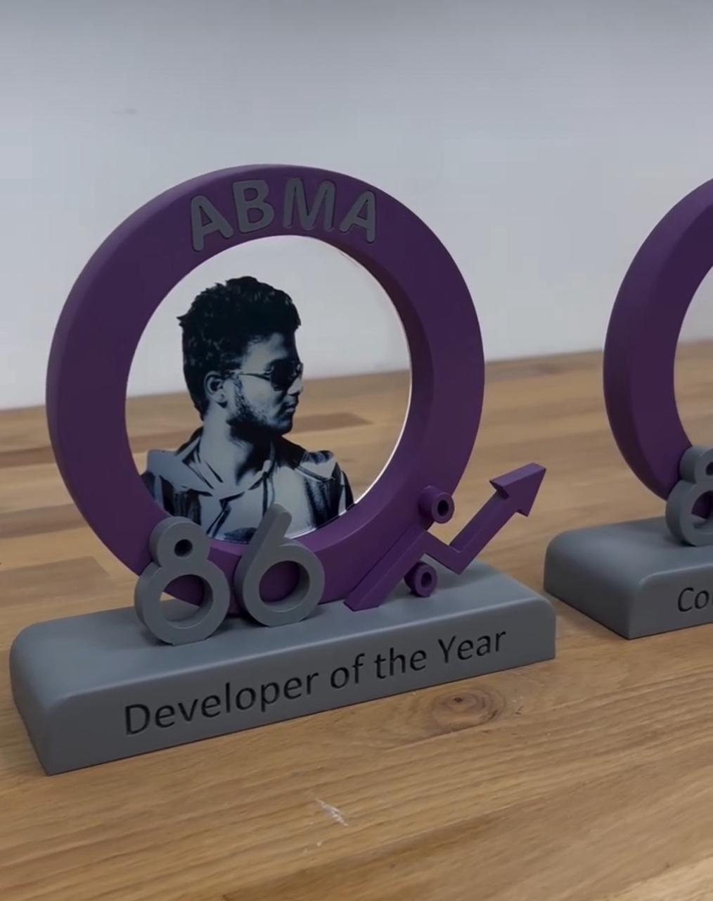 Purple circular personalised award with portrait, raised numbers and Developer of the Year inscription